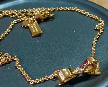 Kate Spade signed gold tone Bow pendant necklace