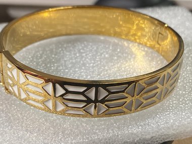 Gold tone with white enameled pattern Stella & Dot Bangle bracelet