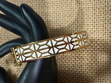 Gold tone with white enameled pattern Stella & Dot Bangle bracelet